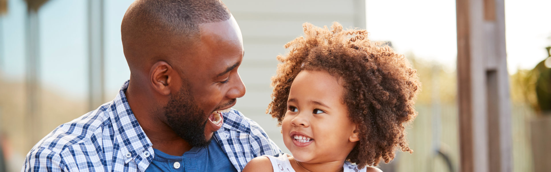 a father smiling to her daughter